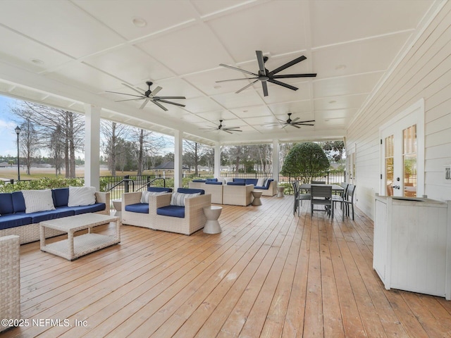 wooden terrace featuring ceiling fan and an outdoor living space