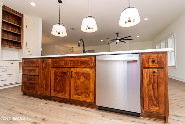 kitchen with light wood-type flooring, ceiling fan, stainless steel dishwasher, and decorative light fixtures