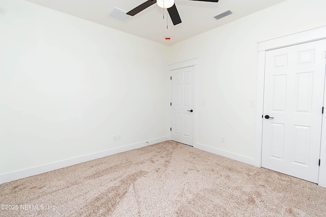 spare room featuring ceiling fan and carpet flooring