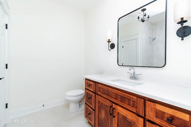 bathroom with toilet, tile patterned flooring, walk in shower, and vanity