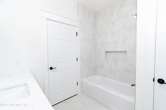 bathroom featuring bathtub / shower combination, vanity, and tile patterned floors