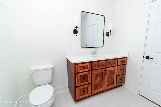 bathroom featuring toilet, vanity, and tile patterned flooring