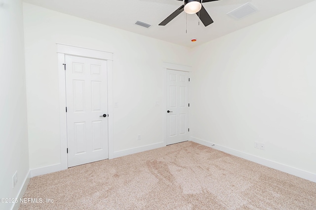 unfurnished room with ceiling fan and carpet floors