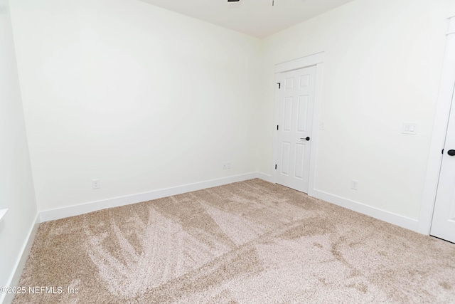 unfurnished room featuring ceiling fan and carpet floors