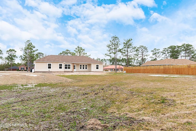 rear view of house with a yard