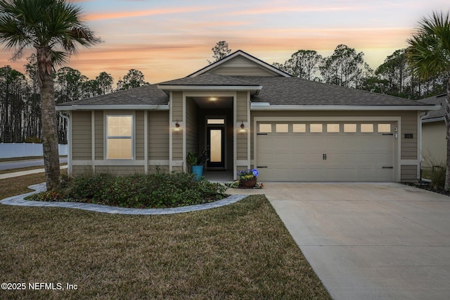 view of front of property featuring a lawn and a garage