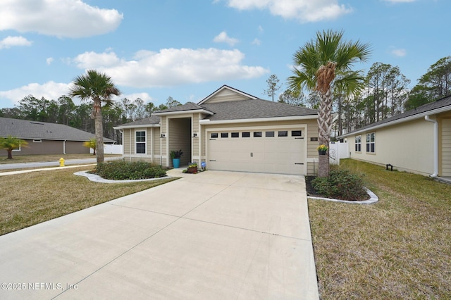 view of front of house with a garage and a front lawn