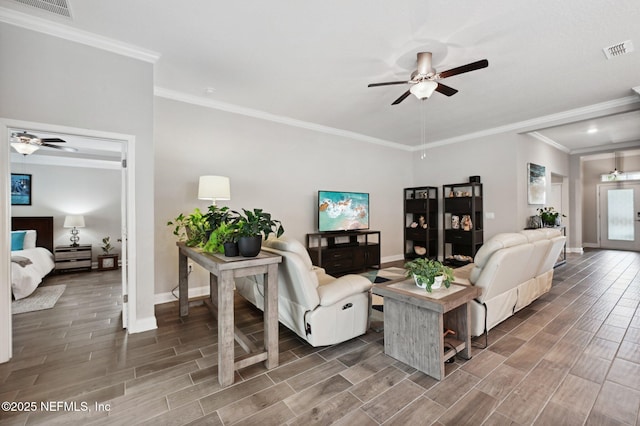 living room with ceiling fan and ornamental molding