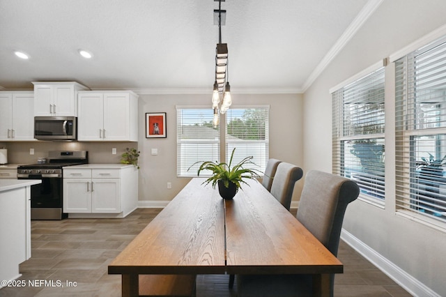 dining room featuring ornamental molding and light hardwood / wood-style floors