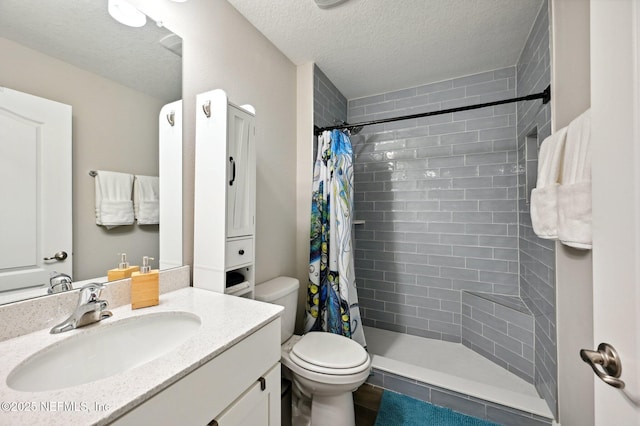 bathroom featuring curtained shower, toilet, vanity, and a textured ceiling