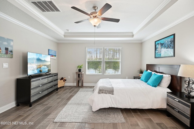 bedroom featuring ceiling fan, ornamental molding, and a raised ceiling