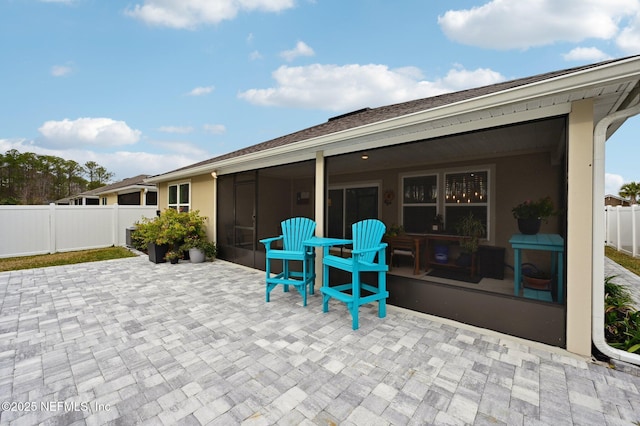 view of patio featuring a sunroom