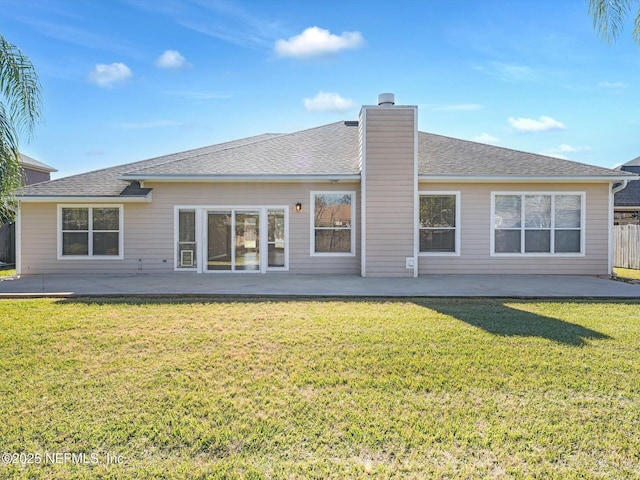 back of property featuring a patio and a lawn