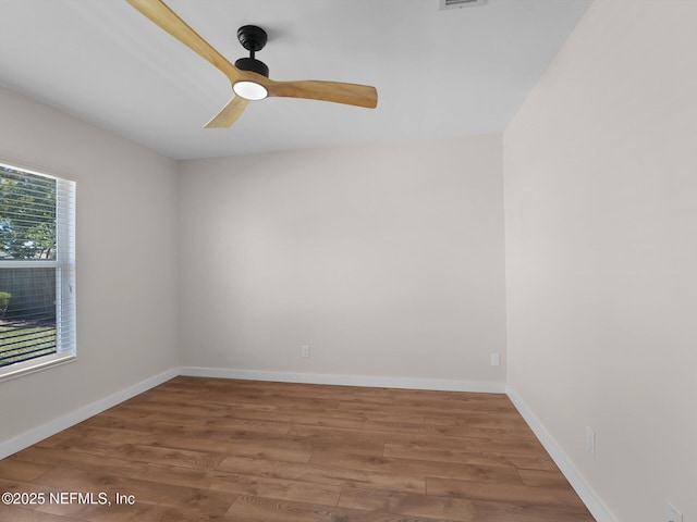 spare room with wood-type flooring and ceiling fan