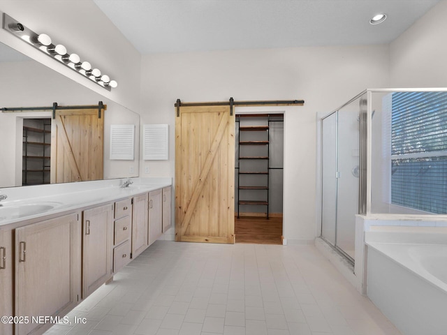 bathroom with tile patterned flooring, vanity, and separate shower and tub