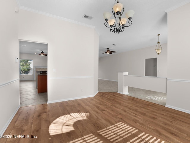 unfurnished living room featuring hardwood / wood-style flooring, ceiling fan with notable chandelier, and ornamental molding