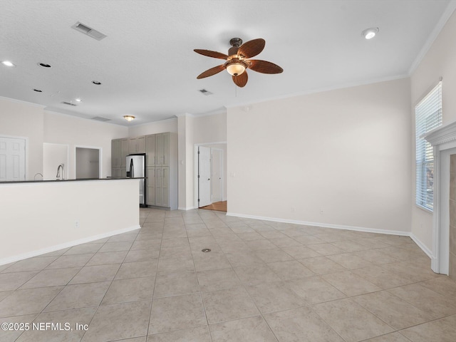 tiled empty room with crown molding and ceiling fan