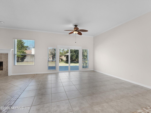 unfurnished living room with light tile patterned floors, crown molding, a fireplace, and a healthy amount of sunlight