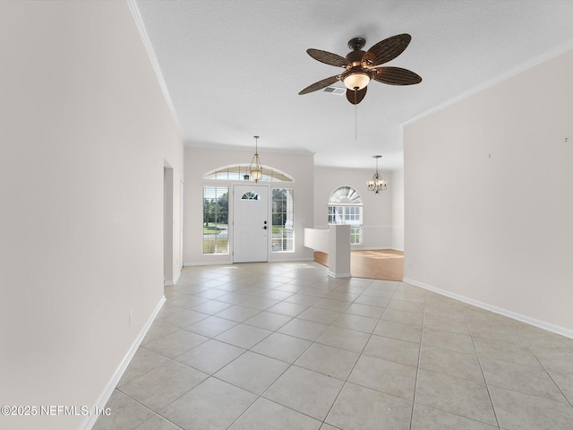 unfurnished living room featuring ornamental molding, light tile patterned floors, and a textured ceiling