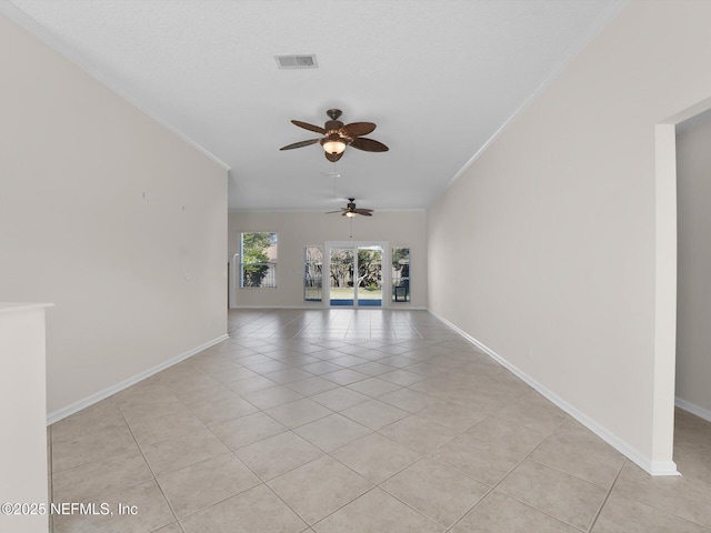 unfurnished living room with crown molding, light tile patterned floors, ceiling fan, and a textured ceiling