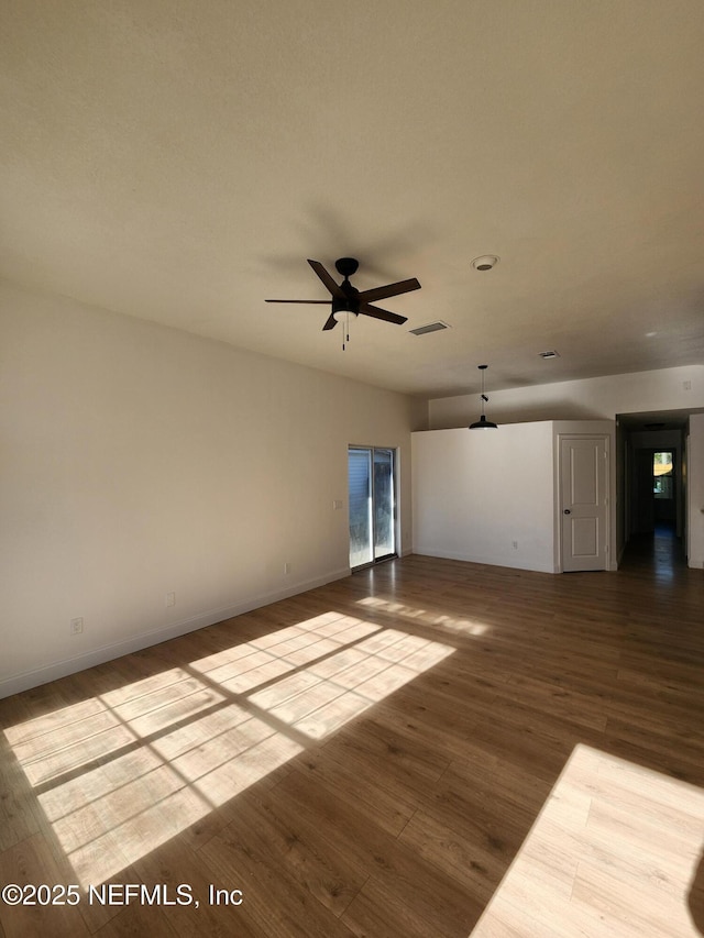 empty room with ceiling fan and wood-type flooring