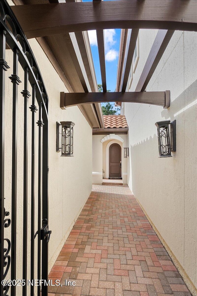 view of exterior entry with a tiled roof