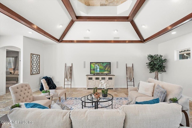 living area with lofted ceiling with beams, baseboards, visible vents, and arched walkways