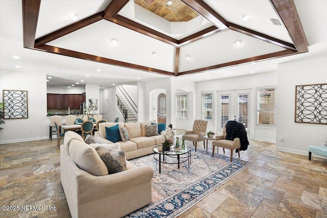 living room featuring baseboards, stairway, recessed lighting, and stone tile floors