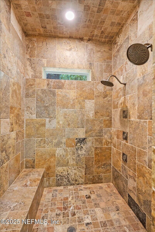 bathroom with a tile shower