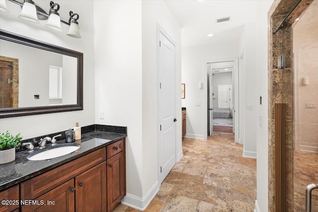 bathroom with vanity and a shower with shower door