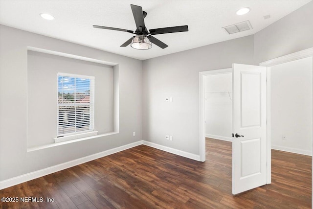 spare room featuring baseboards, visible vents, dark wood-style floors, ceiling fan, and recessed lighting