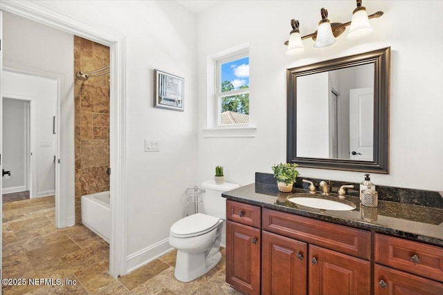 full bathroom featuring baseboards, toilet, stone finish flooring, bathtub / shower combination, and vanity