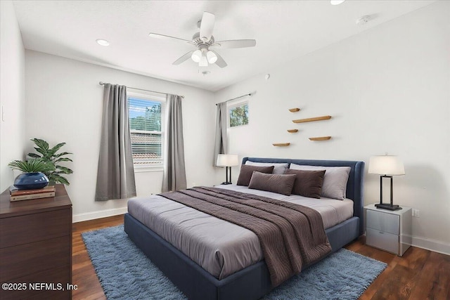 bedroom featuring a ceiling fan, dark wood-style flooring, and baseboards