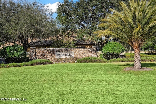 community sign featuring a lawn