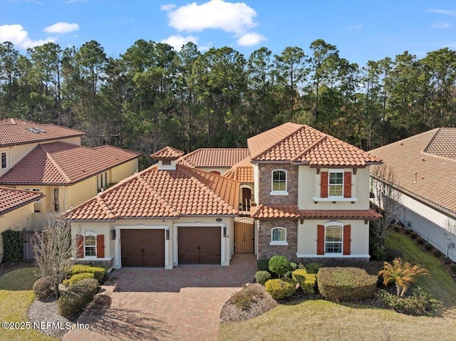 mediterranean / spanish-style house featuring a garage