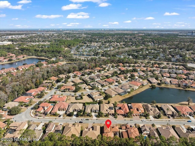 drone / aerial view with a water view and a residential view