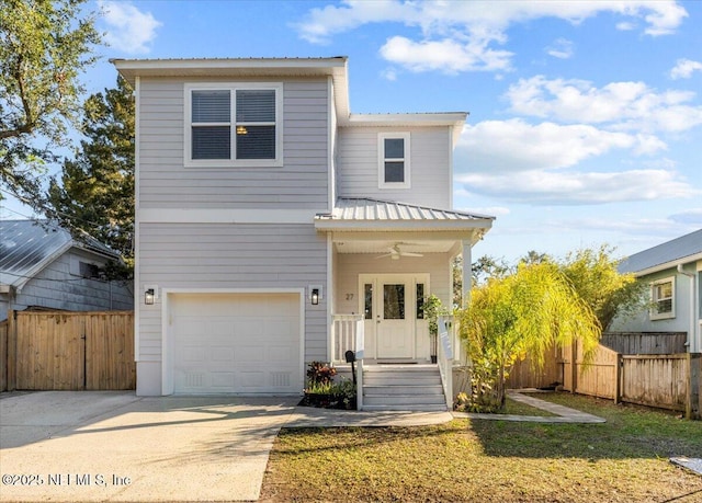 view of front of home featuring ceiling fan, a front lawn, and a garage