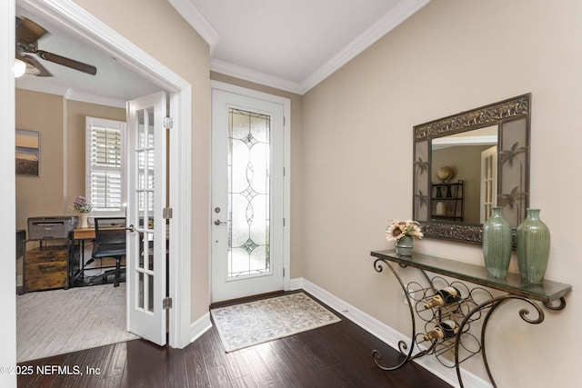 entrance foyer featuring crown molding, a healthy amount of sunlight, and hardwood / wood-style floors