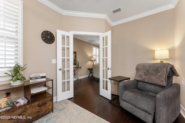 sitting room with crown molding, dark wood-type flooring, and french doors