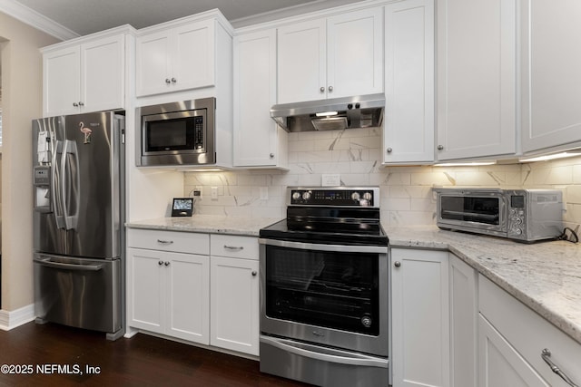 kitchen with crown molding, stainless steel appliances, and white cabinets