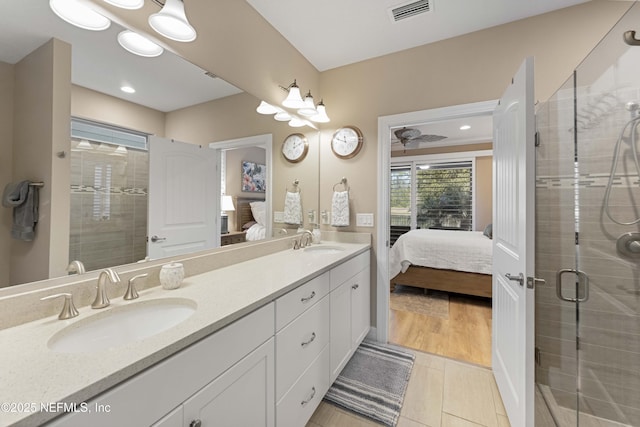 bathroom featuring vanity and an enclosed shower