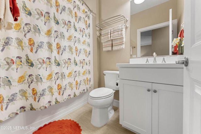 full bathroom featuring vanity, shower / tub combo, and toilet