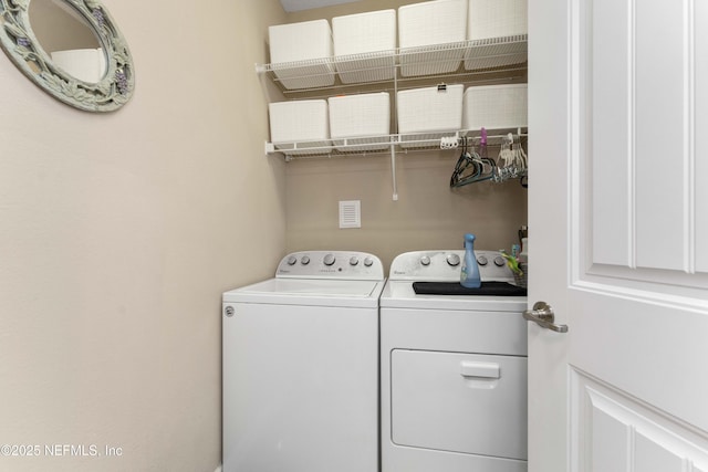 laundry area featuring washing machine and clothes dryer