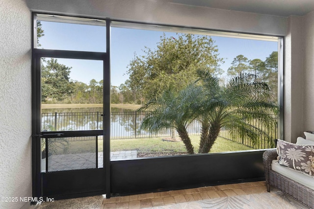 unfurnished sunroom with a water view