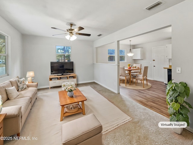 living room featuring ceiling fan and hardwood / wood-style floors