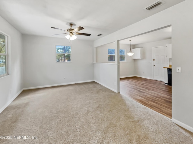 spare room with ceiling fan and carpet