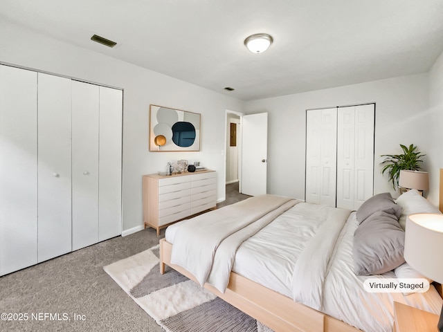 bedroom with carpet floors and multiple closets