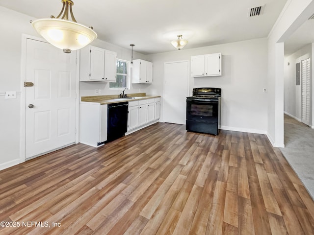 kitchen featuring black appliances, white cabinetry, light hardwood / wood-style floors, sink, and hanging light fixtures