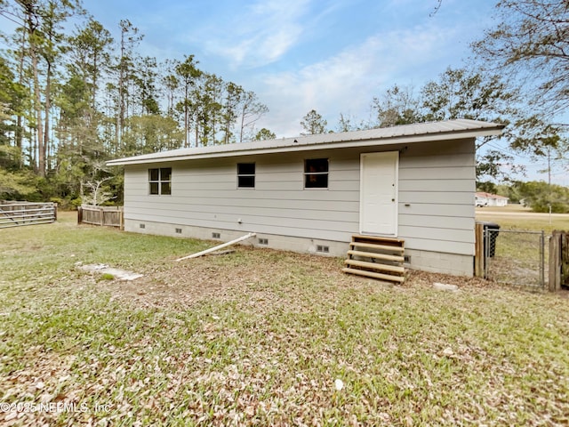 back of property featuring a lawn