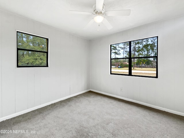 empty room featuring ceiling fan and carpet floors